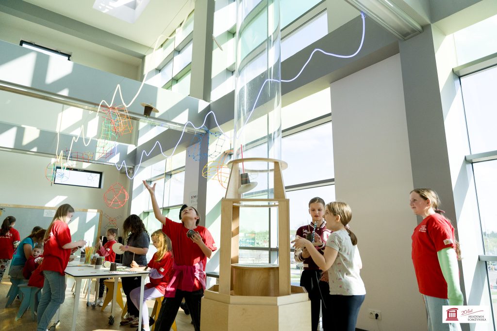 Children engaged in interactive science activities at a well-lit educational center
