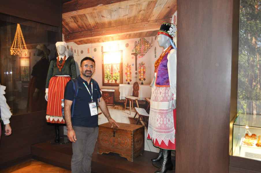 Mężczyzna oglądający stroje ludowe w muzeum