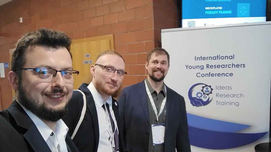 Trzech mężczyzn - pracowników Wydziału Nauk Informatyczno-Technologicznych na konferencji naukowej
